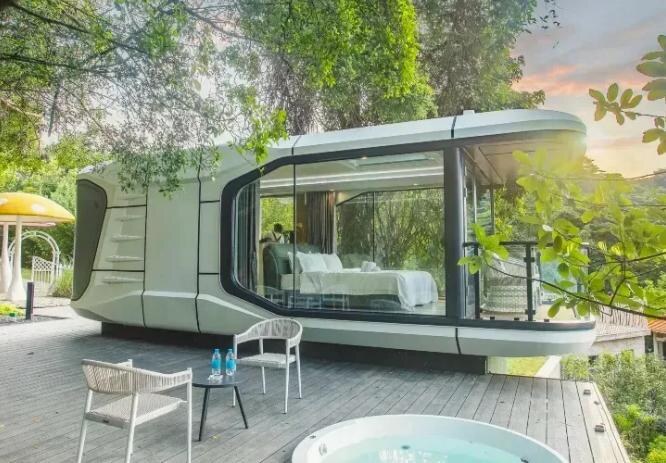 Manufacturer-supplied image of a rounded cabin with broad glazing in a landscaped setting