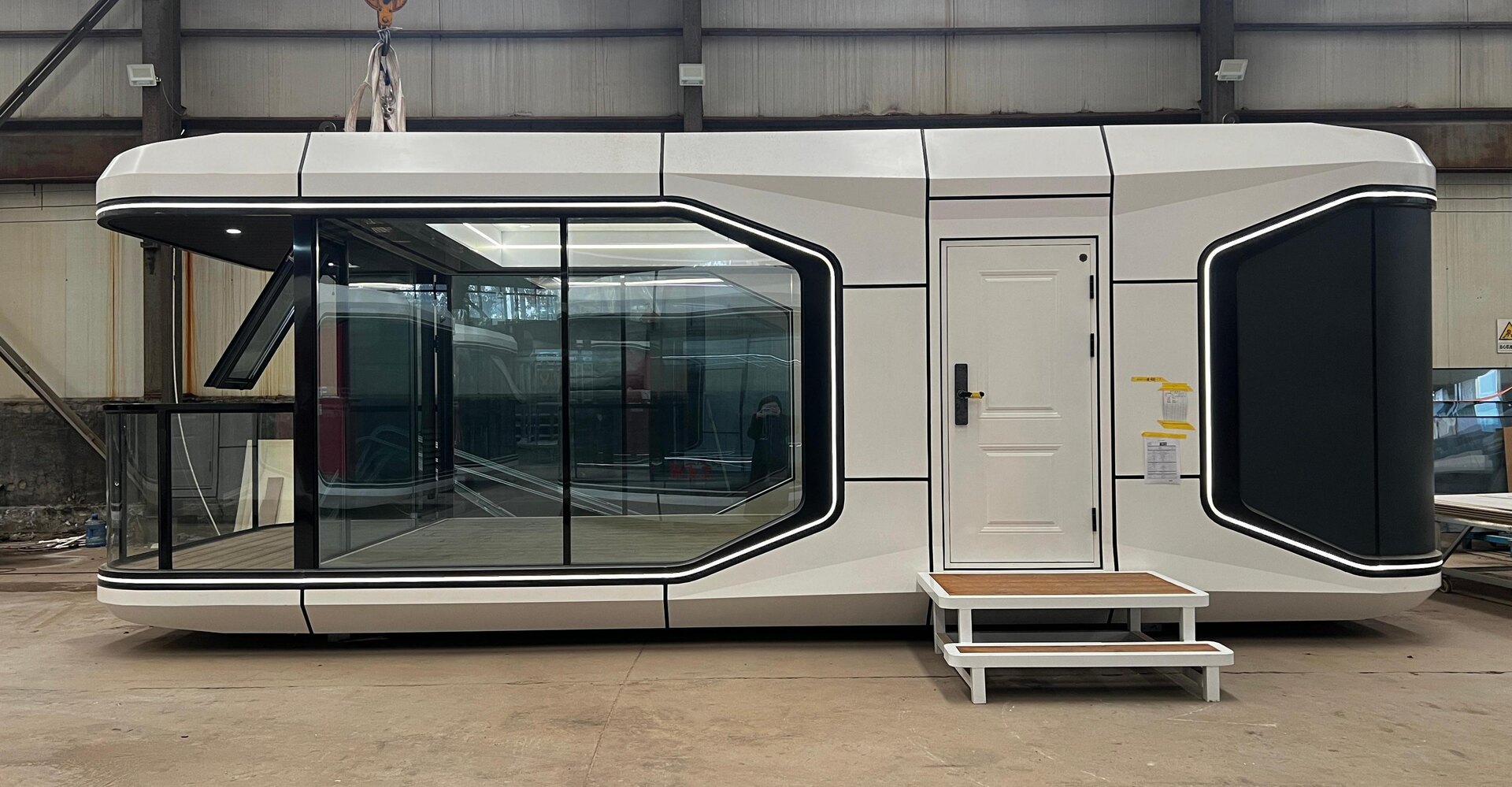 Manufacturer-supplied photograph of a capsule-style modular unit in a factory setting